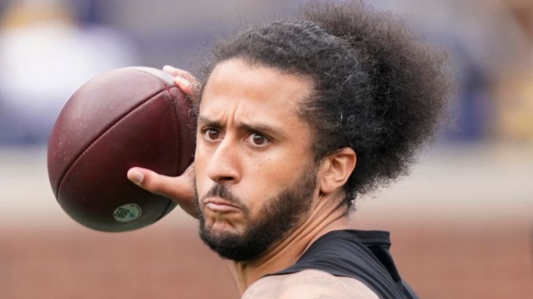 FILE- free agent quarterback Colin Kaepernick throws during halftime of an NCAA college football intrasquad spring game at Michigan, on April 2, 2022,
